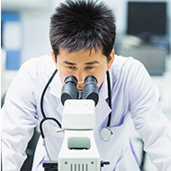 A person looking through a microscope